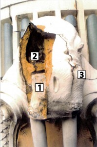 Figure 6: 1996 inspection photo of walrus head S-1. Note the white grout sections filling the sinus cavity area of the walrus head (1). This meant there was no space left for the grout to expand into when the gypsum got wet. Note also the crack in the internal webbing (2). The damage to the internal structure of the head was so severe that this head had to be replaced. Note the cracks radiating from the dot on the top right of the walrus snout (3). This dot is the injection point for the 1982 grout installation and created a weak point in the terra cotta. Credit: Morden & Slaton, WJE.