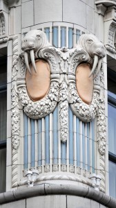 Figure 1: The double walrus heads at the southwest corner of the Arctic Building in Seattle, Washington. Note the highly decorative terra cotta, bright colorful palette, and the tusks that hang from the walrus heads. Credit: Brian Rich, 2013.